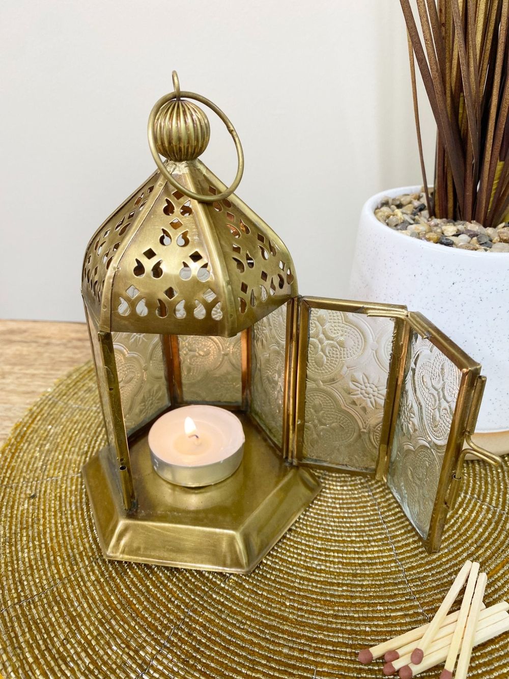 Open gold Moroccan Kasbah latern with burning tealight candle