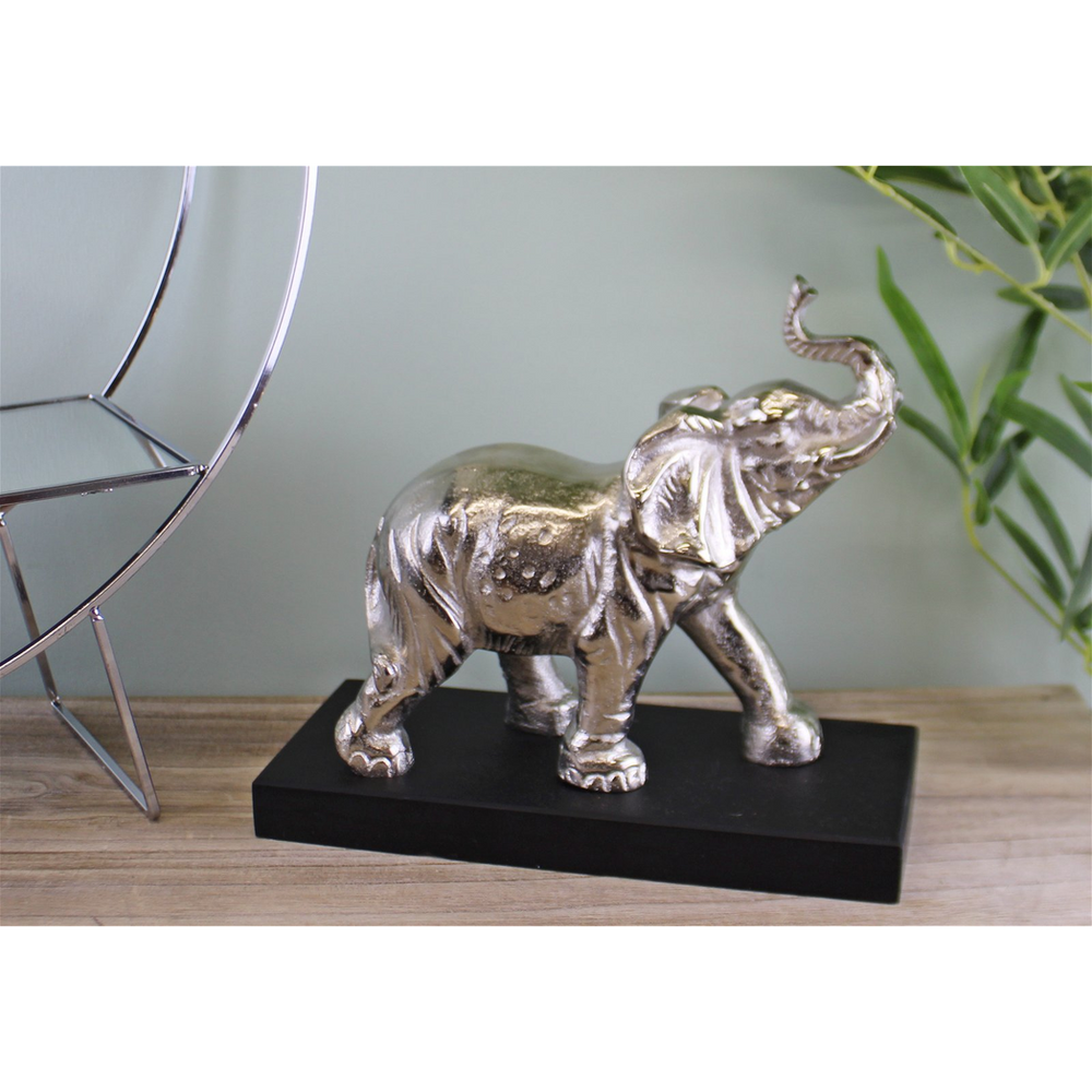 Silver elephant statue on black base