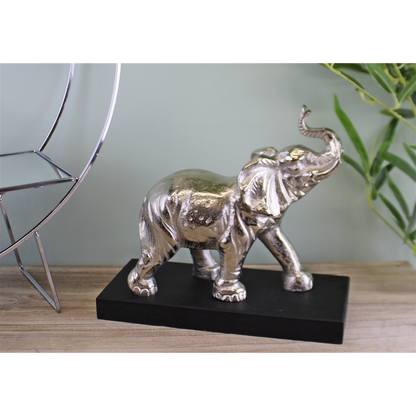 Silver elephant statue on black base